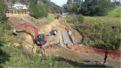 Looking along the work site below Bush Road. The top timber retaining wall is shown to the left, while the toe wall can be seen in the middle of the image