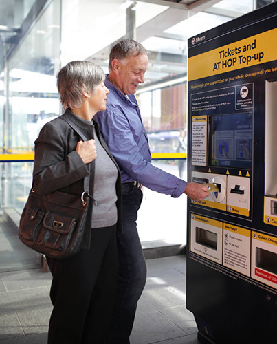 Customers using a ticket and top-up machine