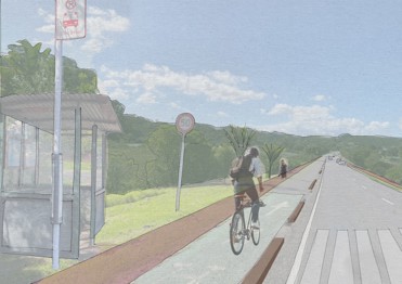 Person riding a bike in a bike lane with a bus stop on the left.
