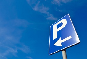 A sign showing a paid parking area.
