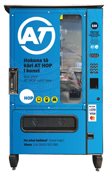 A blue vending machine that sells AT HOP card.