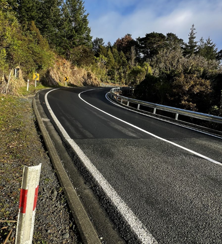 Matakana Valley Road site 9, with new road seal, fresh painted road markings and a new guard rail.