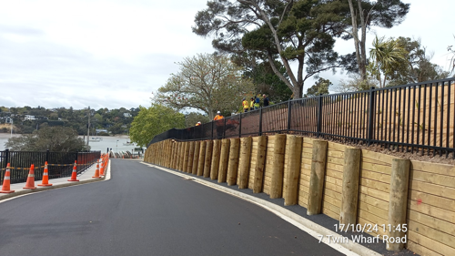 Newly paved road, new timber retaining wall with new safety fencing at the top completes the work on this section of Twin Wharf Road.