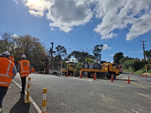 Construction crew begin to arrive on site with their equipment.