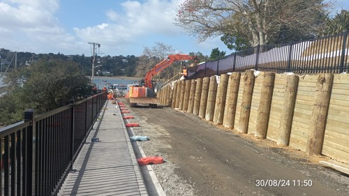 Excavator installing black safety fencing on Twin Wharf Road